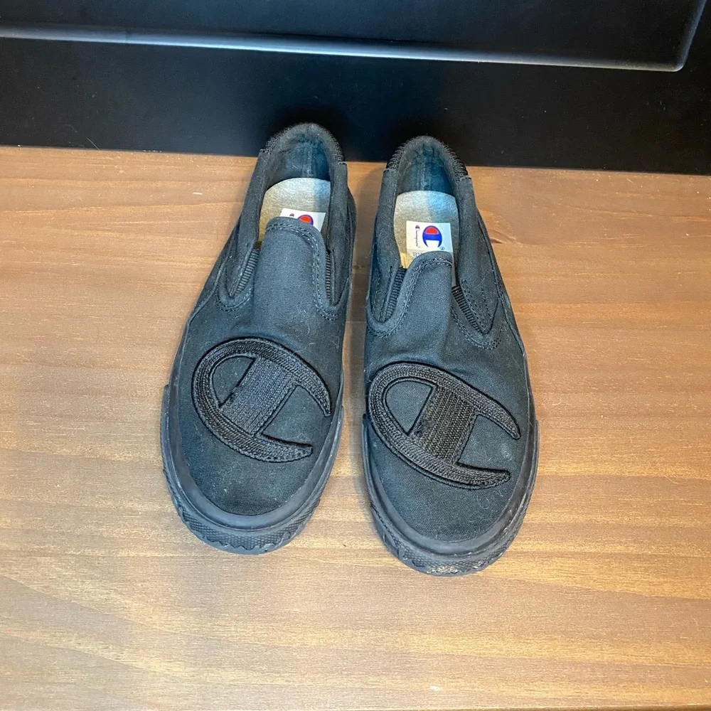 Champion black slip-ons size 5.5Y (kids size), size 7 in women’s